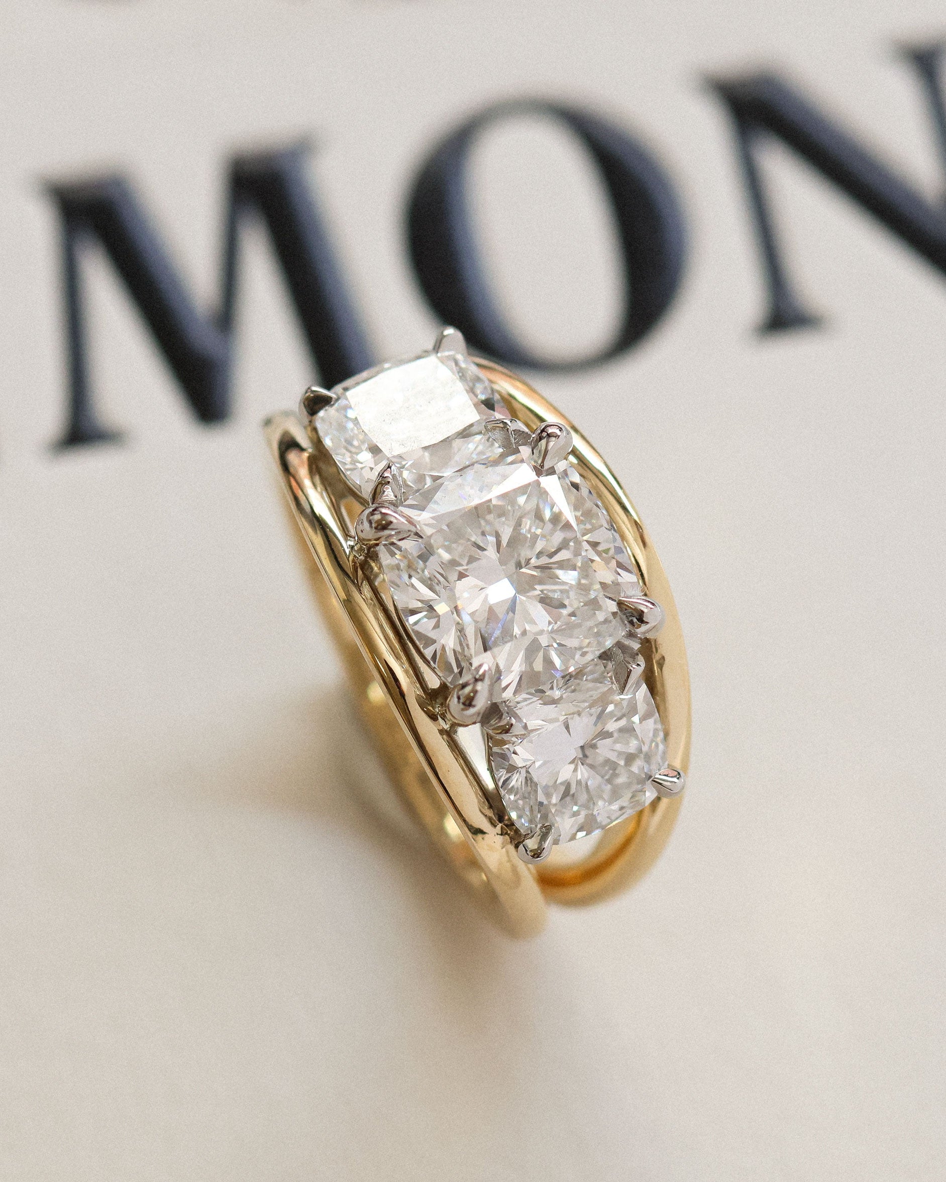 Vintage inspired cushion cut diamond trilogy ring.
