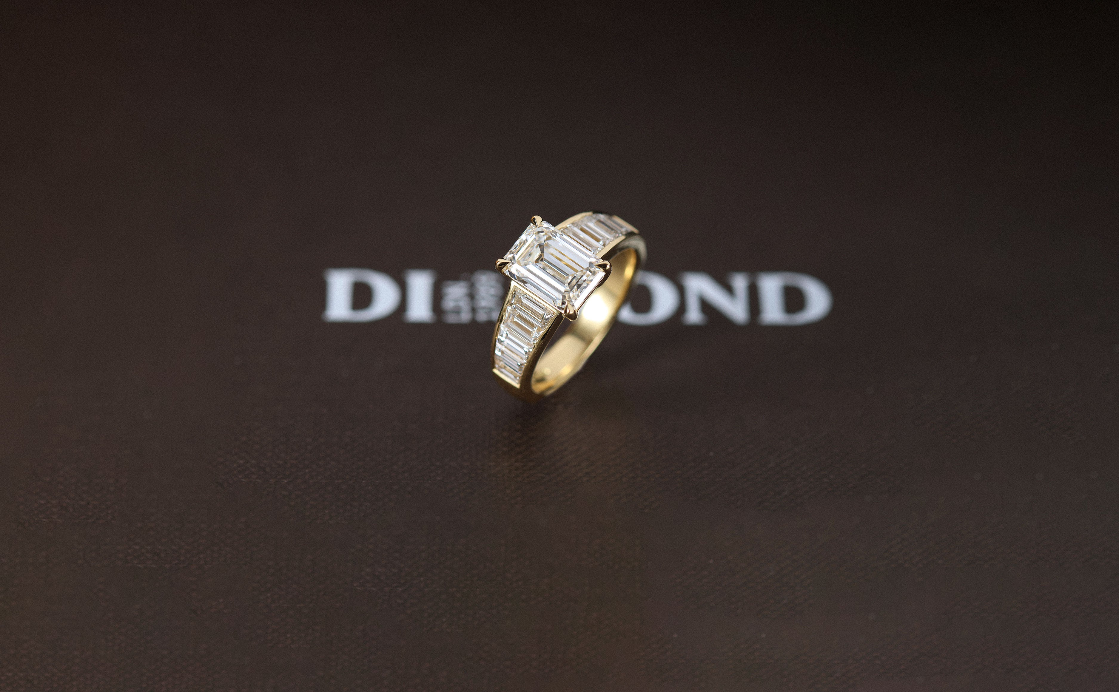 Art Deco engagement ring with emerald cut diamond and side baguette diamonds.